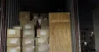 Cartons and a wooden crate loaded for origin transport in Shenzhen at night.