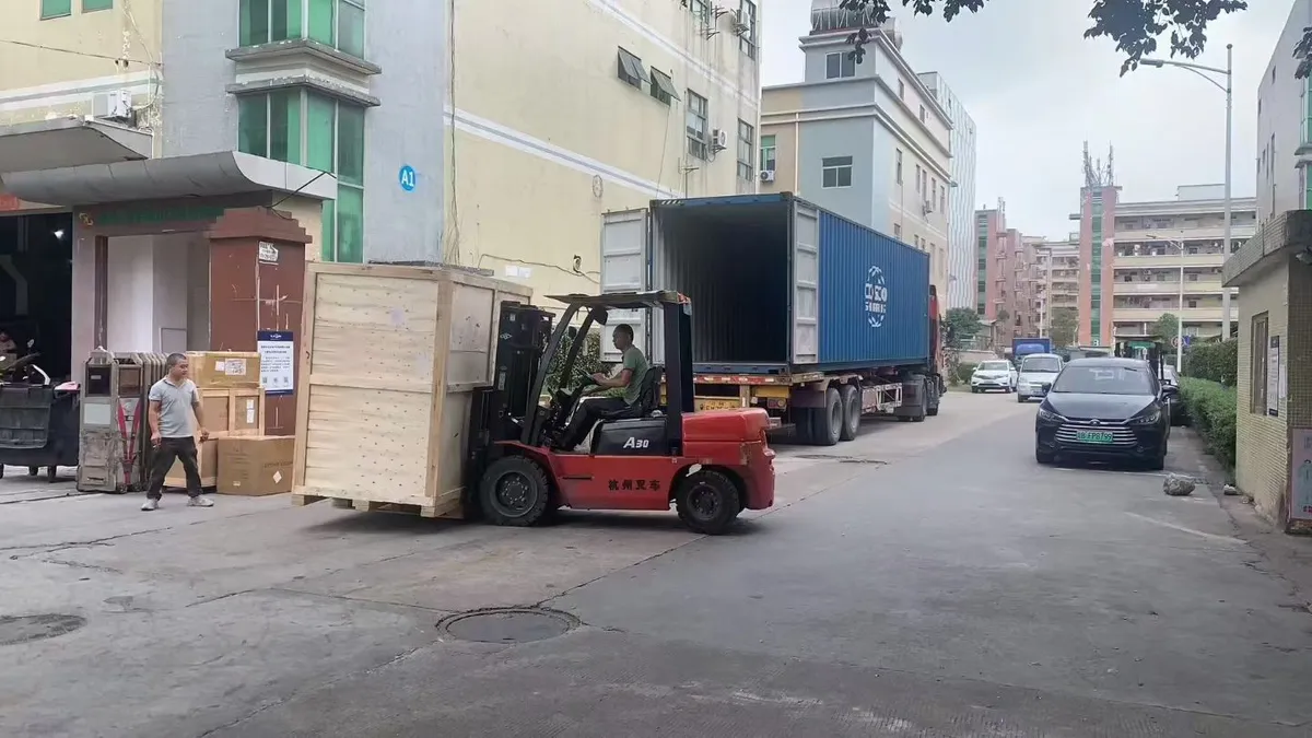 Forklift handling a wooden furniture crate beside an open container at the Zhejiang factory.